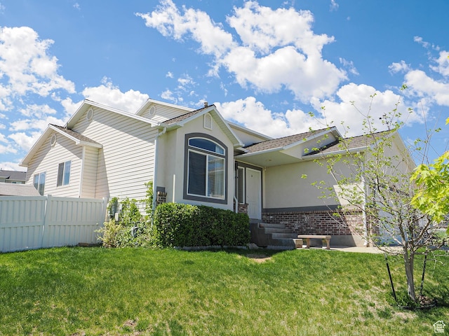 ranch-style home featuring brick siding and stucco siding