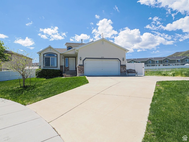 ranch-style house with stucco siding, driveway, an attached garage, and stone siding