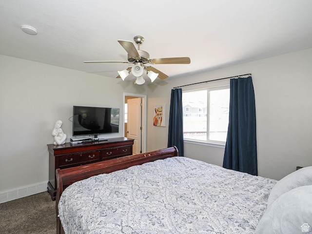 carpeted bedroom with ceiling fan and baseboards