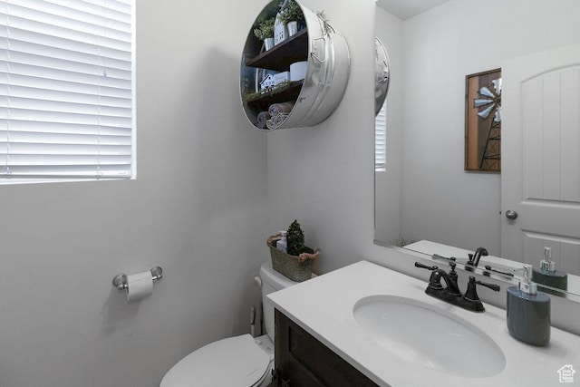 half bathroom with toilet and vanity