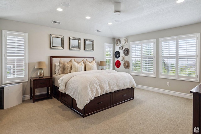 bedroom with light colored carpet, baseboards, recessed lighting, and a textured ceiling