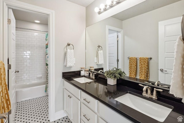 full bath with double vanity, shower / bath combination with curtain, and baseboards