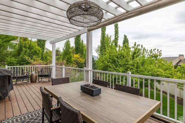 wooden deck featuring outdoor dining space and a pergola