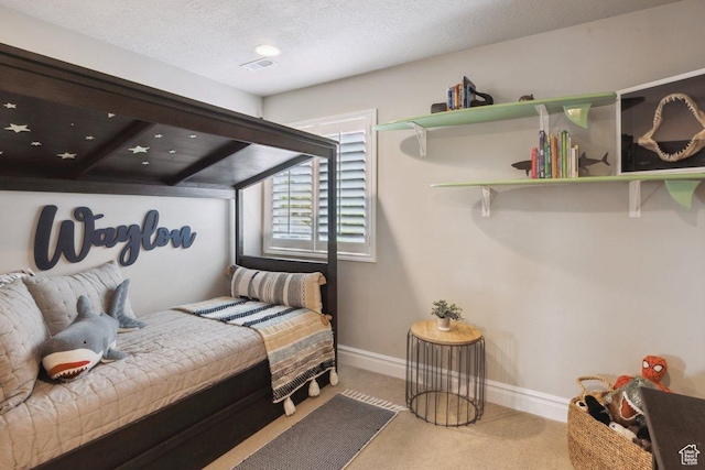 bedroom featuring carpet flooring, baseboards, and a textured ceiling