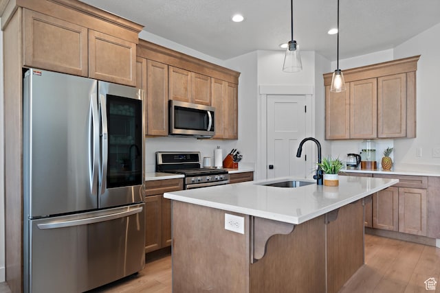 2005 N 4260 W, Lehi, UT 84043 - kitchen featuring stainless steel appliances, a sink, light wood-style flooring, light countertops, and a kitchen bar