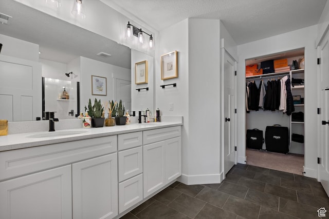 2005 N 4260 W, Lehi, UT 84043 - full bathroom featuring double vanity, baseboards, a spacious closet, and a textured ceiling