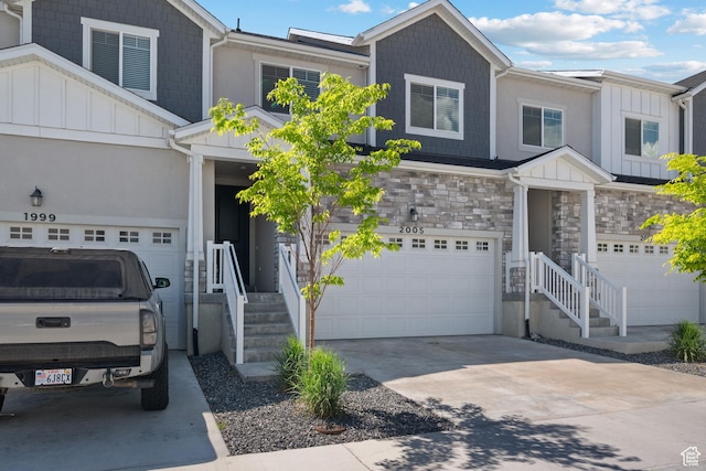 2005 N 4260 W, Lehi, UT 84043 - view of front of property with board and batten siding, an attached garage, concrete driveway, and stone siding