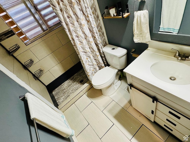 full bathroom with toilet, a shower stall, vanity, and tile patterned floors