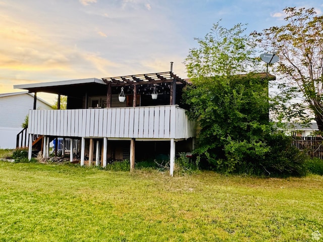 back of house with a yard, a pergola, stairs, and a deck