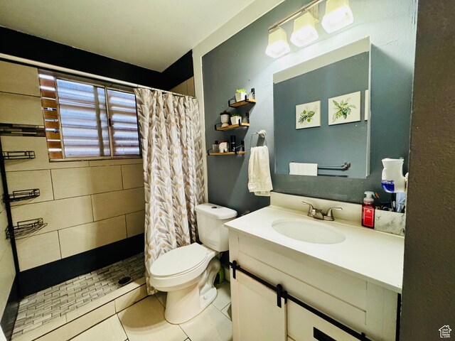 full bathroom with a tile shower, vanity, toilet, and tile patterned flooring