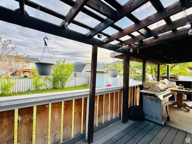 deck with a grill, fence, a pergola, and a residential view