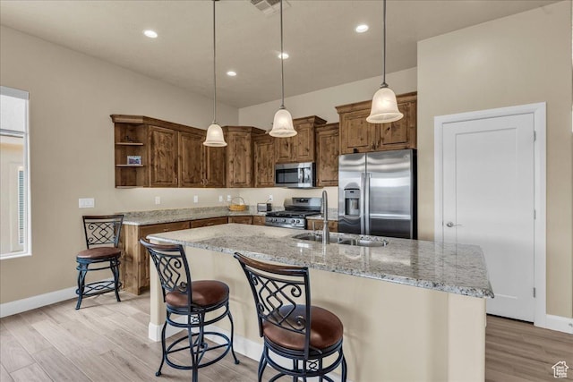 kitchen featuring appliances with stainless steel finishes, open shelves, a sink, baseboards, and recessed lighting
