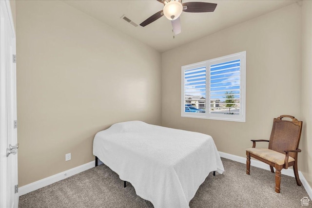 carpeted bedroom featuring baseboards and a ceiling fan
