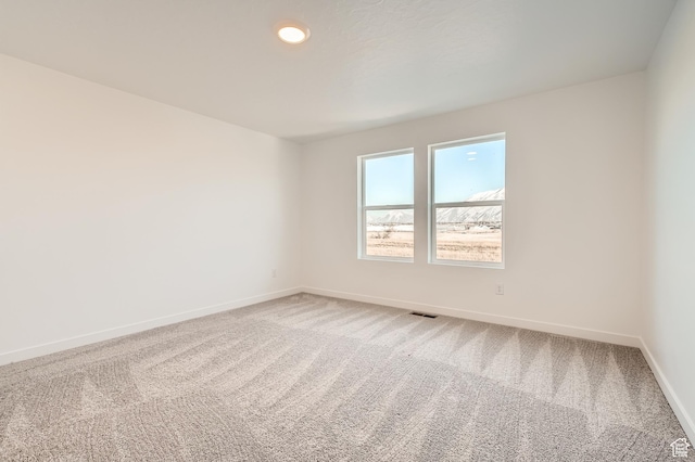 spare room with carpet flooring and baseboards