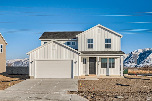 modern inspired farmhouse with board and batten siding, concrete driveway, and a mountain view