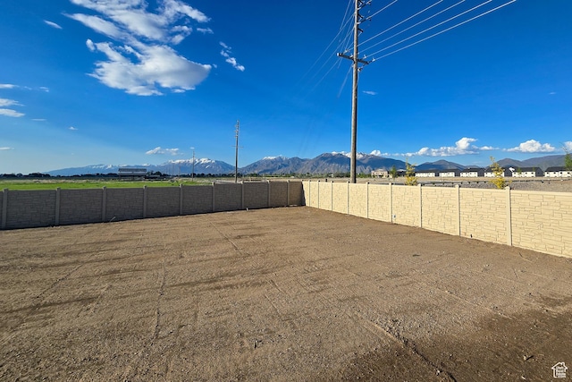 fenced backyard featuring a mountain view