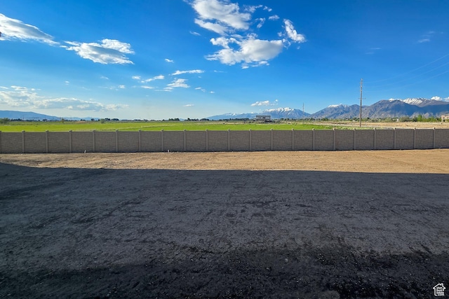 view of yard with a mountain view and an enclosed horse arena