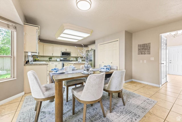 8017 S Showcase Ln, Sandy, UT 84094 - dining area featuring light tile patterned floors, baseboards, a chandelier, and a textured ceiling