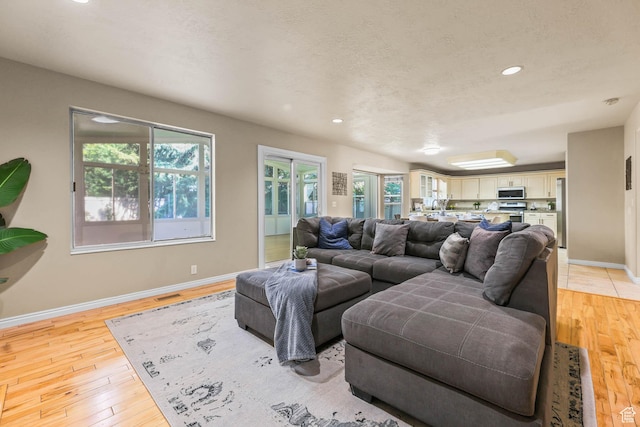 8017 S Showcase Ln, Sandy, UT 84094 - living area featuring light wood-style floors, baseboards, and recessed lighting