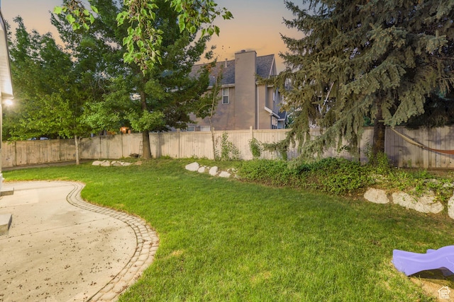 8017 S Showcase Ln, Sandy, UT 84094 - yard at dusk featuring a patio area