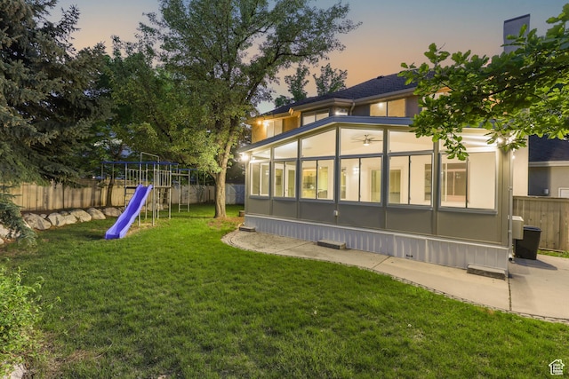 8017 S Showcase Ln, Sandy, UT 84094 - view of yard with a sunroom and a playground