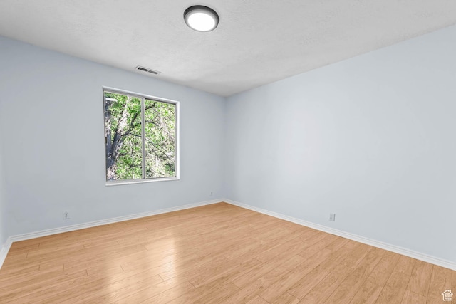 8017 S Showcase Ln, Sandy, UT 84094 - spare room with light wood finished floors, baseboards, and a textured ceiling