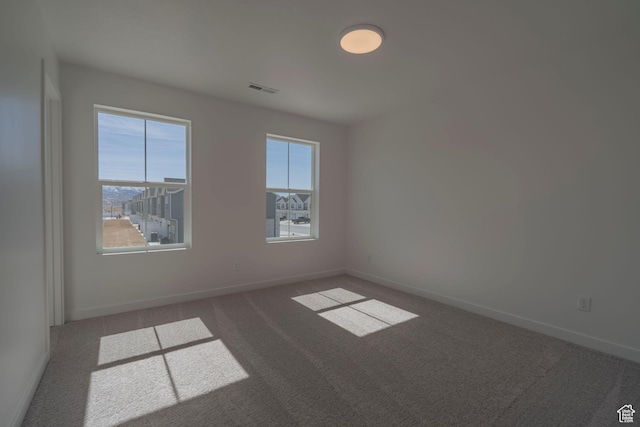 empty room with carpet flooring and baseboards