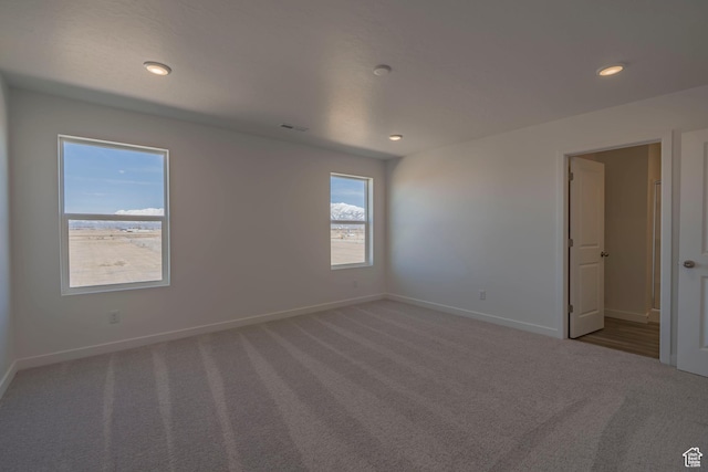 unfurnished room with carpet floors, baseboards, and recessed lighting