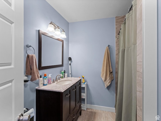 full bathroom featuring vanity, wood finished floors, and a shower with shower curtain
