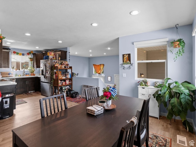 dining room with light wood-style floors and recessed lighting
