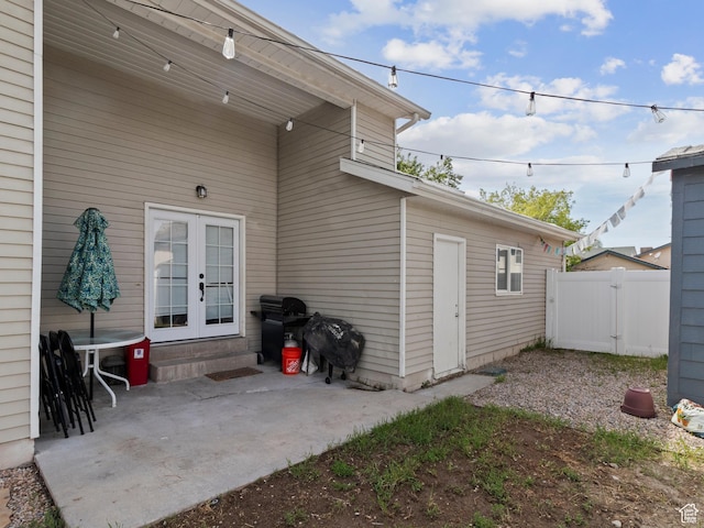 view of patio featuring french doors and fence
