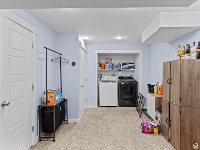 laundry area featuring independent washer and dryer, carpet flooring, and baseboards