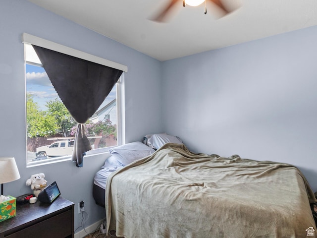 bedroom with multiple windows and a ceiling fan