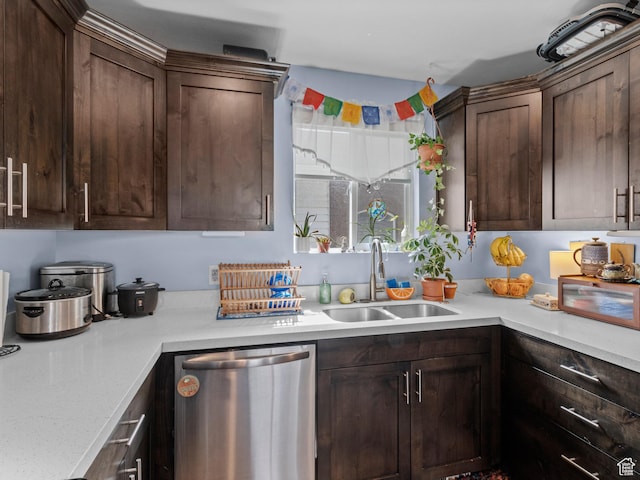 kitchen featuring stainless steel dishwasher, a sink, light countertops, and dark brown cabinets