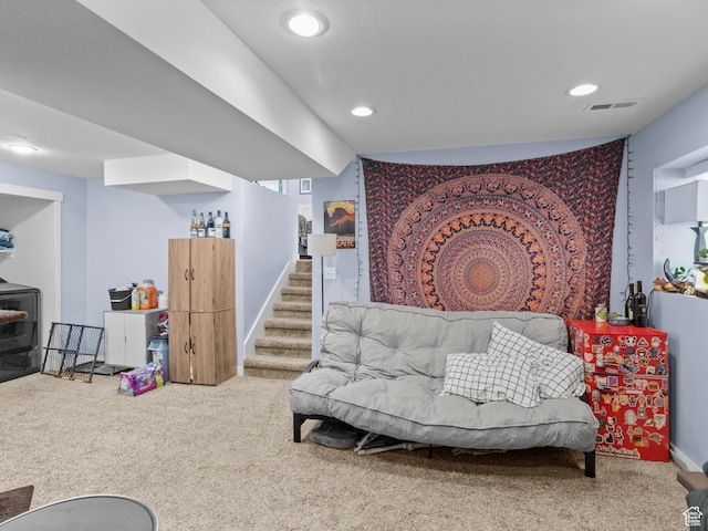 carpeted living room with recessed lighting and stairs