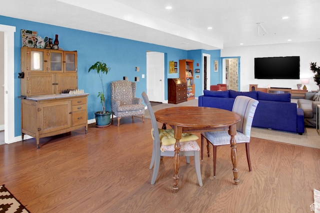 dining space with wood finished floors, recessed lighting, and baseboards