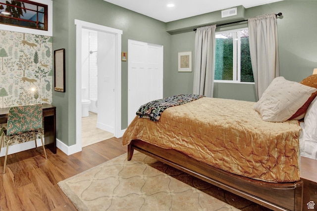 bedroom with wood finished floors, baseboards, recessed lighting, and ensuite bathroom