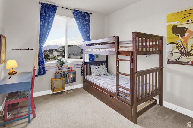 bedroom featuring carpet floors and baseboards