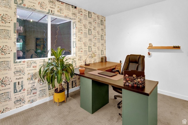 office area featuring baseboards and carpet