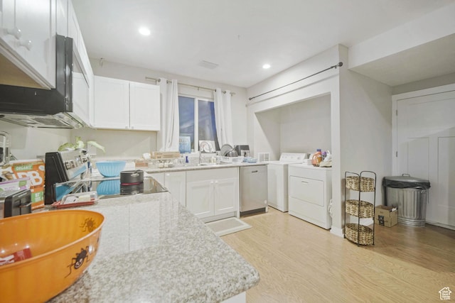 kitchen with light wood-type flooring, a sink, appliances with stainless steel finishes, white cabinets, and recessed lighting