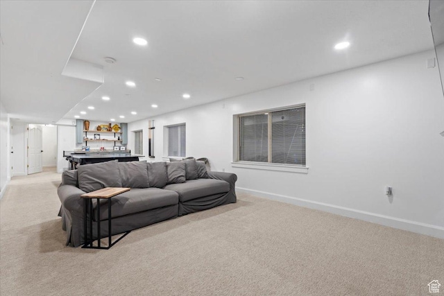 living room featuring light colored carpet, recessed lighting, and baseboards