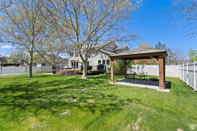 view of yard with a gazebo, a wooden deck, and a patio