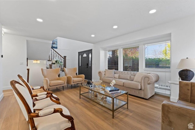 living room with light wood-type flooring, stairway, recessed lighting, and baseboards
