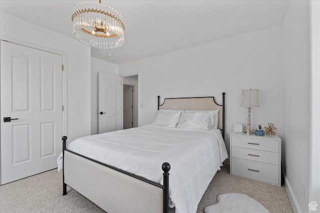 bedroom with light colored carpet and a chandelier