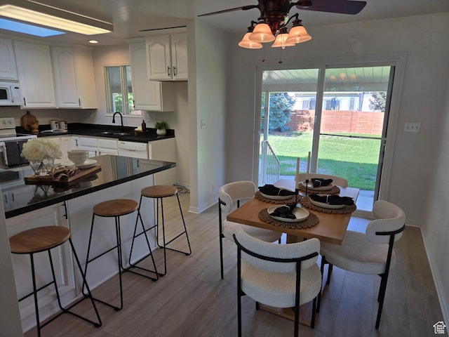 1731 S 145 E, Orem, UT 84058 - dining area featuring light wood-type flooring, ceiling fan, and baseboards