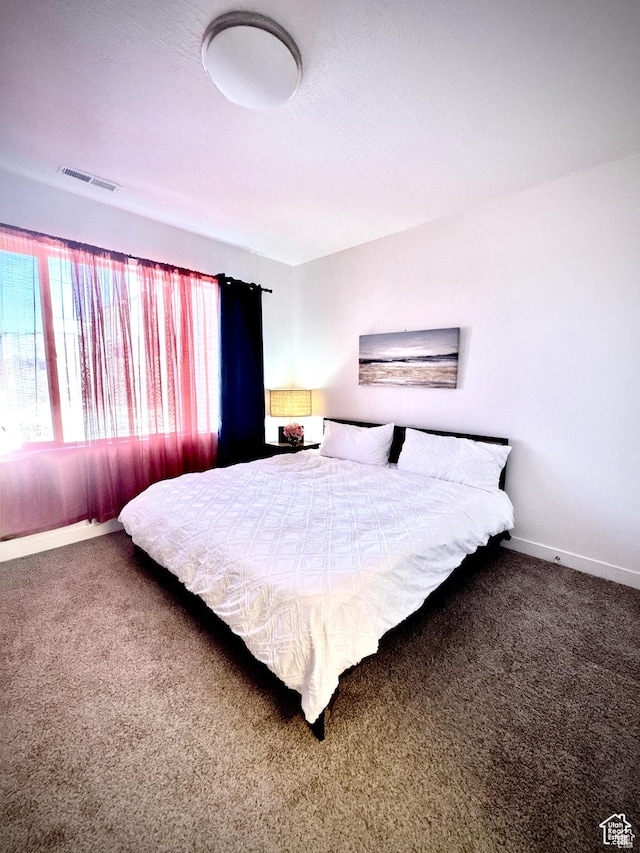 bedroom featuring carpet and baseboards