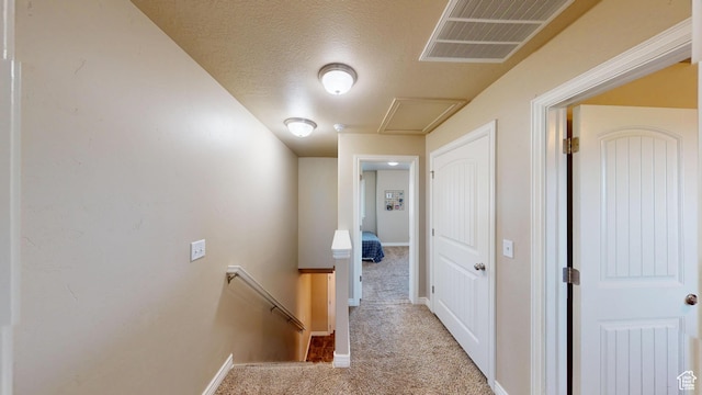 90 W Cedar Ln, Franklin, ID 83237 - corridor with an upstairs landing, carpet floors, baseboards, attic access, and a textured ceiling