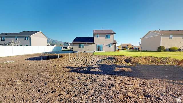 90 W Cedar Ln, Franklin, ID 83237 - view of yard featuring a trampoline, fence, and a residential view