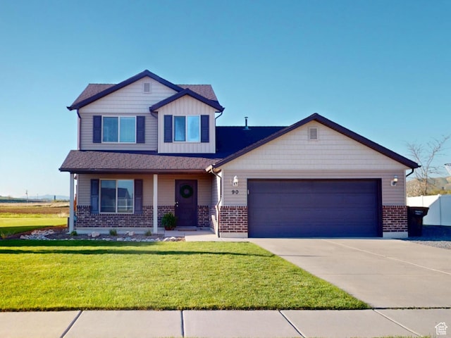 90 W Cedar Ln, Franklin, ID 83237 - view of front of home featuring brick siding, a garage, driveway, a front yard, and a porch