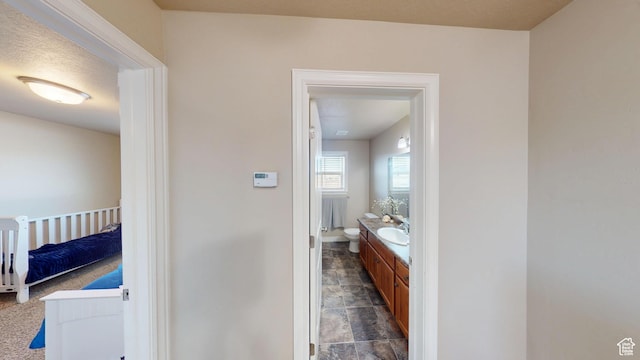 90 W Cedar Ln, Franklin, ID 83237 - bathroom with vanity, stone finish floors, toilet, and baseboards